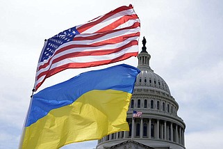The American and Ukrainian flags wave in the wind outside of the Capitol on Tuesday, April 23, 2024, in Washington. President Joe Biden signed into law a bill providing $95 billion in war aid to Ukraine, Israel and Taiwan. (AP Photo/Mariam Zuhaib)